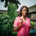 Sayana Press device held in hand of young health worker