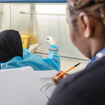 Pharmacist prepares syringe for testing